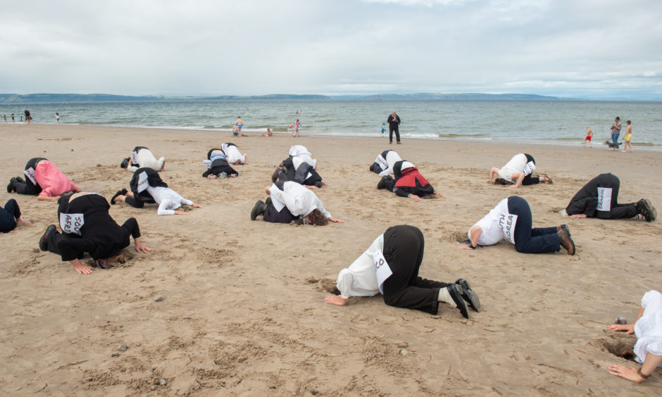 Extinction Rebellion protesters at Nairn beach.
Pictures by Jason Hedges.