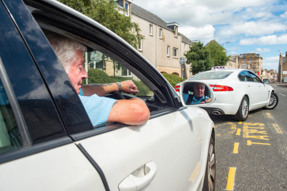 Taxi Driver Harry Williamson from at the taxi rank on South Street in Elgin.
Pictures by Jason Hedges.