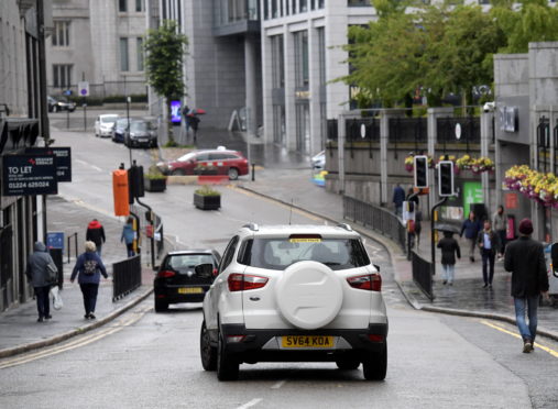 Cars in the pedestrianised section of Schoolhill in Aberdeen. The council removed signs signalling the road closure to "soften" the look of the physical distancing measures, but it is claimed the confusion is risking lives.
Picture by KATH FLANNERY