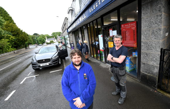 Brendan Will (left) at the store in Cults with his father Martin (right).