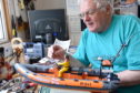Modelmaker Ted Miller shows off his hand crafted collection of lifeboats which he has built. Picture by Sandy McCook.