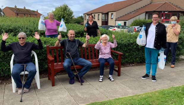 Residents and staff from Burnside Court with community meal volunteers.