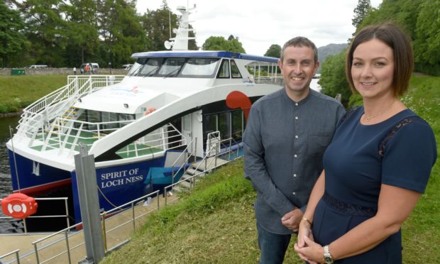 Ronald and Debi Mackenzie from Cruise Loch Ness, beside the Spirit of Loch Ness. Photo by Sandy McCook