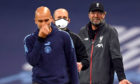 Liverpool manager Jurgen Klopp gestures towards Manchester City manager Pep Guardiola (left) on the touchline.