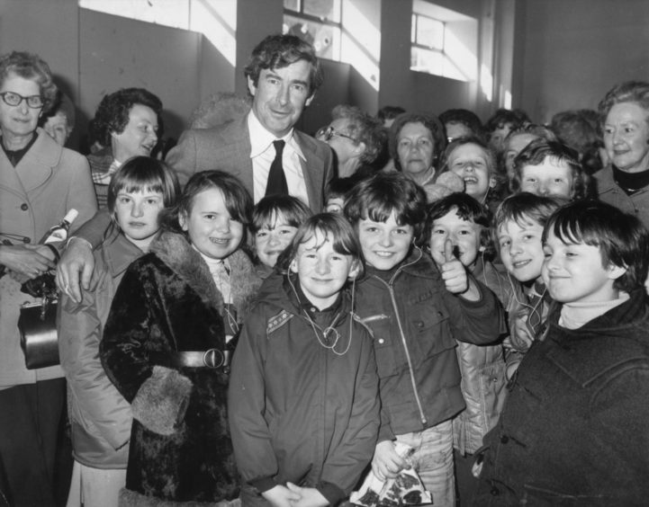 Comedian Dave Allen was delighted when the Aberdeen committee of the International Festival of Youth Orchestras presented him with a bottle of 25-year-old Scotch in 1978. Dave was lending a hand at their Spring sale in Queen's Cross Church Hall.