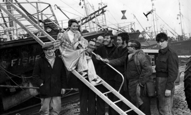 Singing star Lulu is the centre of attention as she visits Aberdeen Harbour in 1973. Lulu was in town to promote the Aberdeen production of Peter Pan in January of that year.