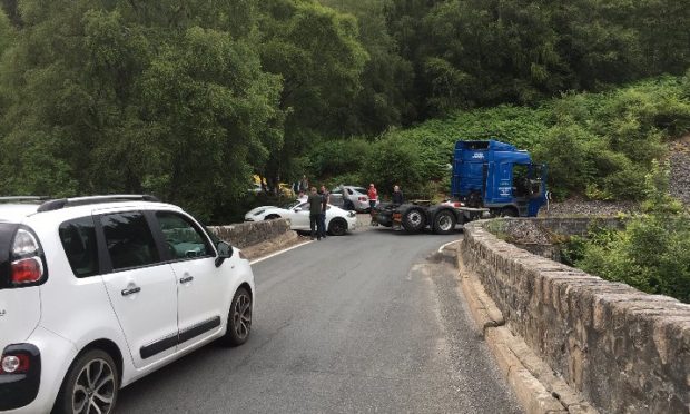 The white Porsche hit the bridge on Struie Hill.