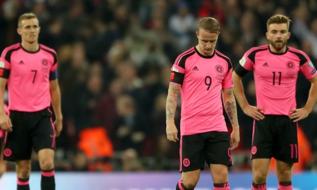 Darren Fletcher, Leigh Griffiths and James Morrison look dejected after England take the lead during a match in 2016.
