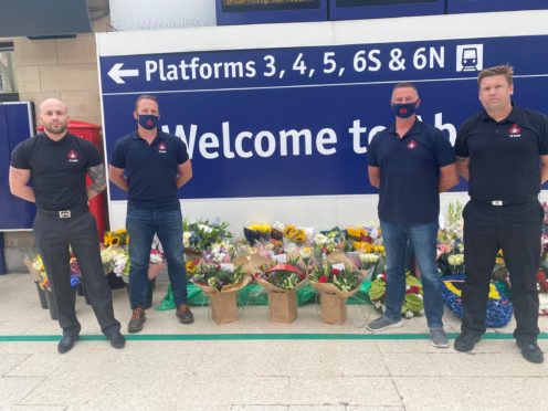 The firefighters laying flowers at Aberdeen train station