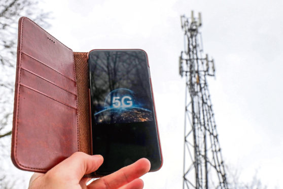 A 5G phone next to a telecoms mast.