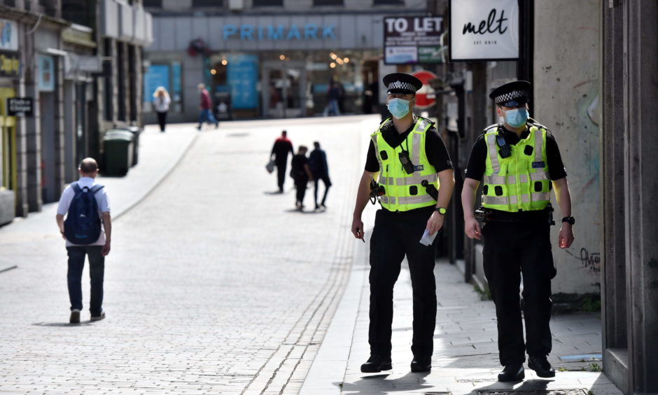 Police officers patrol Union Street and Belmont Street in Aberdeen.