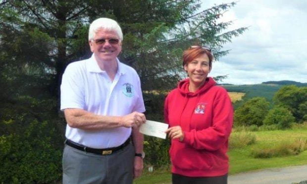 Ron Fowler, provincial grand master of the Freemasons of Moray and Nairn hands over cheque to Moray School Bank's Debbie Kelly.