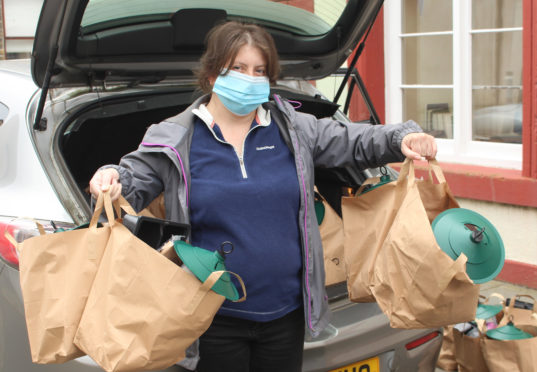 Maysie Calder of Sinclair’s Bay Community Council taking a delivery of Green Health Packs.