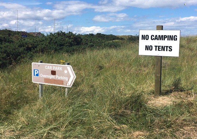 Signage urging campers to stay away.