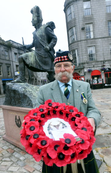 Major Bob Donald, the secretary of the Aberdeen branch of the Gordon Highlanders association with the wreath before the ceremony began. Picture by Chris Sumner