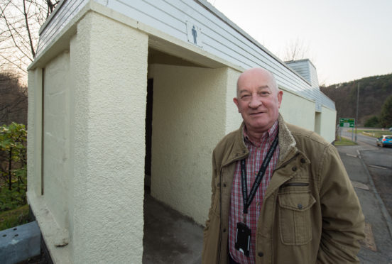 Councillor Derek Ross outside public toilets in Craigellachie.