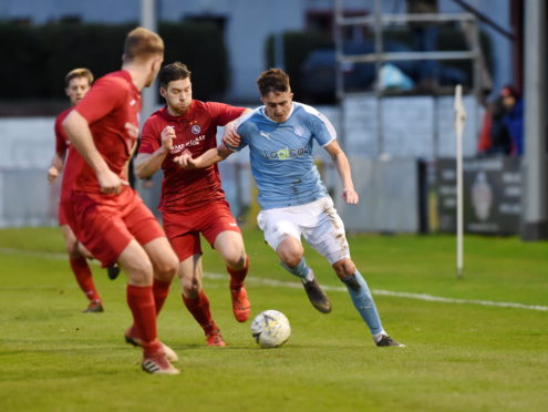 Scott Davidson of Nairn in action against Brora