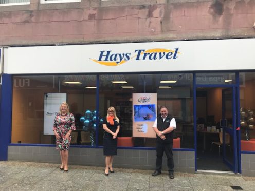 Councillor Diane Beagrie and Jimmy Buchan cut a ribbon to mark the opening of the new shop.