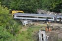 A crane is brought in to the scene near Stonehaven, Aberdeenshire, following the derailment of the ScotRail train.