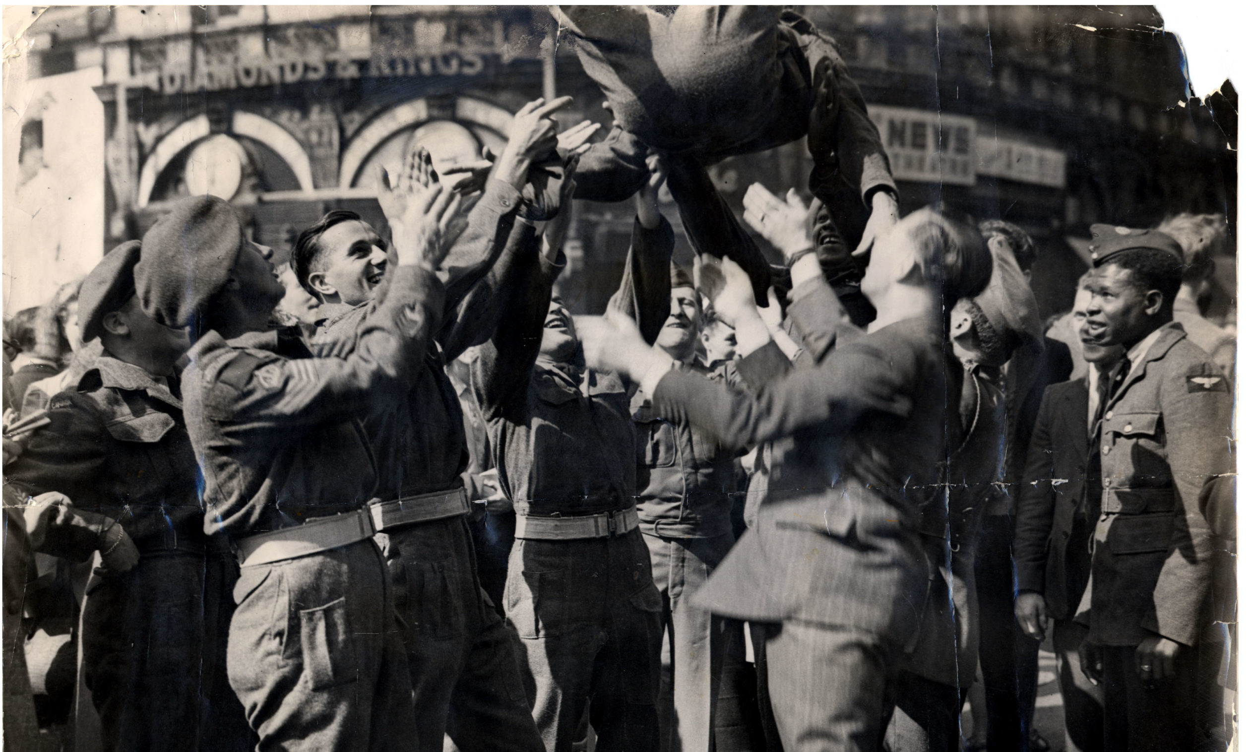 Soldiers celebrating Victory over Japan in Piccadilly Circus, London.