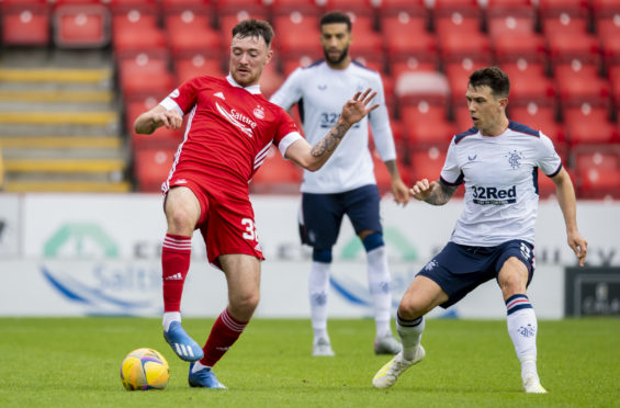 Ryan Edmondson holds off Rangers' Ryan Jack.