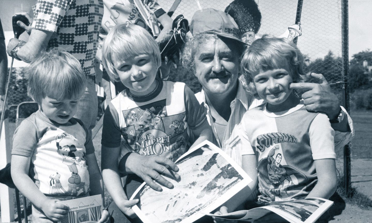 Film star Bernard Cribbins signs autographs for Cults brothers Anthony, David and Sasha Gudd at the Aberdeen Petroleum Club Pro-Cel-Am tournament in aid of SPARKS (Sport Aiding medical Research for Kids) at Deeside Golf Club in 1977.