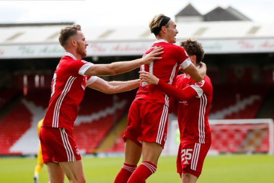 Marley Watkins, left, celebrates Aberdeen's second with creator Ryan Hedges and scorer Scott Wright.