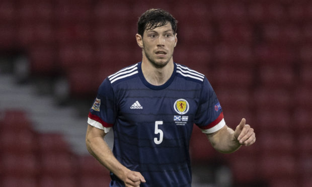 Or will former Dons team-mate Scott McKenna, pictured, and Kieran Tierney being fit see him drop to the bench?