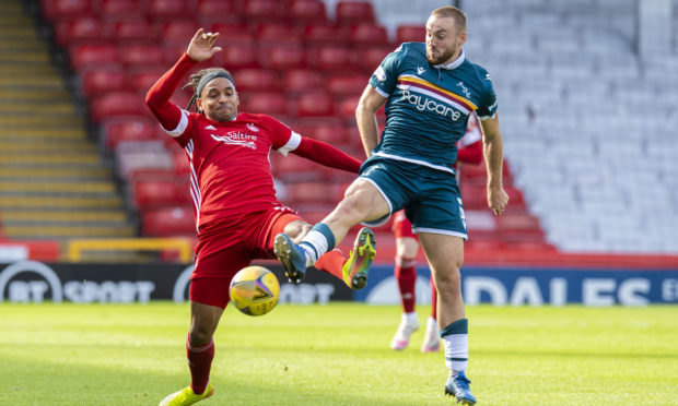 Aberdeen's Funso-King Ojo and Motherwell's Allan Campbell in action during a Scottish Premiership match.
