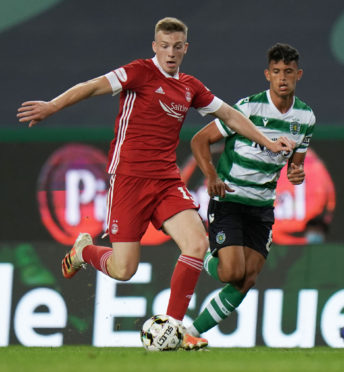 Aberdeen's Lewis Ferguson (left) holds off Sporting's Matheus Nunes