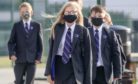 School pupils wear masks to classes.