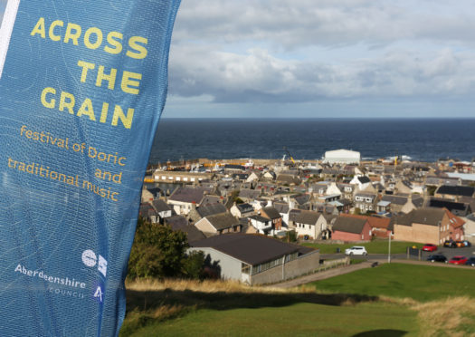 Councillor Anne Stirling, Saskia Gibbon from Aberdeenshire Council, and fiddler Tom Spiers launch Across the Grain at Macduff.