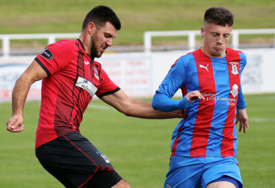 Daniel MacKay, right, challenges Elgin City defender Matthew Cooper.