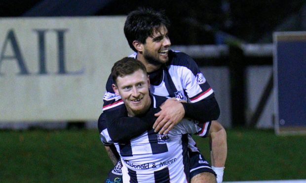 Shane Sutherland is congratulated by Rabin Omar.