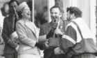The Queen bursts out laughing on the final day of the Braemar Gathering as resin on the hand of caber champion Brian Robin makes for a sticky handshake in 1990.