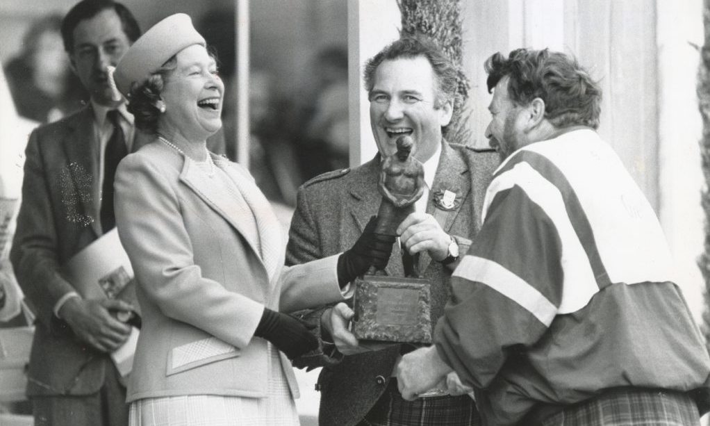 The Queen bursts out laughing on the final day of the Braemar Gathering 1990, as resin on the hand of caber champion Brian Robin makes for a sticky handshake