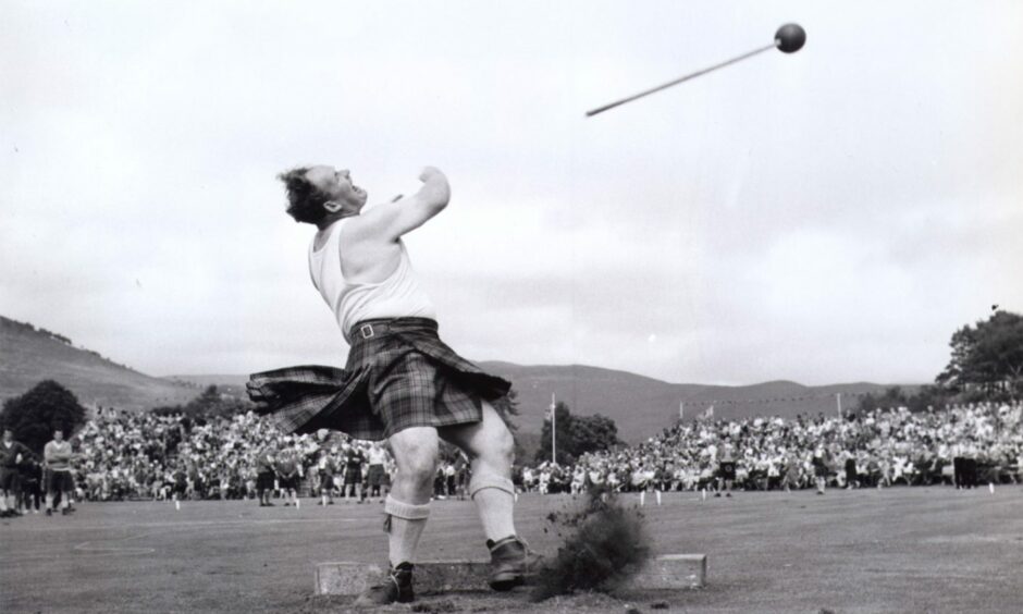 Local games heavyweight Bill Anderson puts the maximum effort into his hammer throw at the Braemar Gathering in 1969.