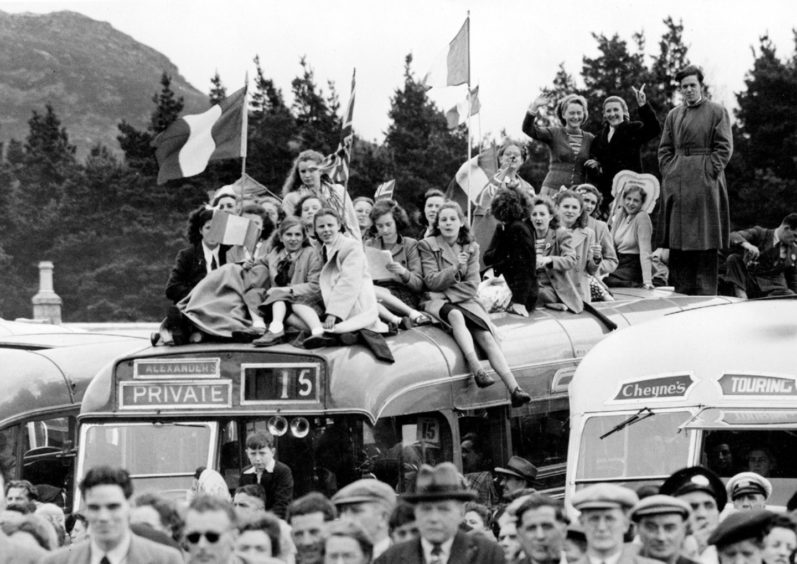 Spectators get an elevated view of the Gathering on top of an Alexander's bus.