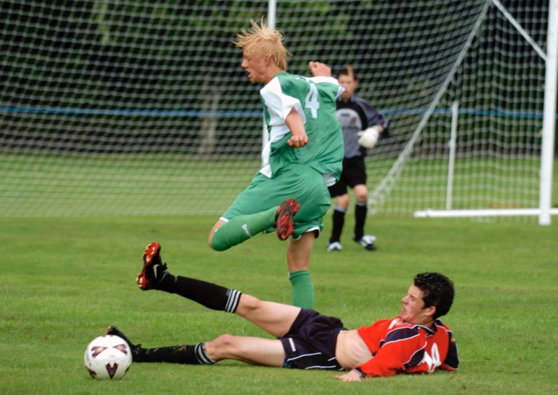 Canada's Jamie Glaval is tackled by Northern Ireland's John Campbell at AIFF 2005