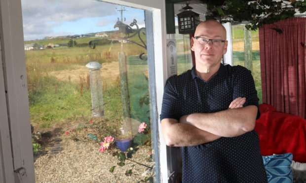 David Young moved into his garden greenhouse to protect his wife and mother.
