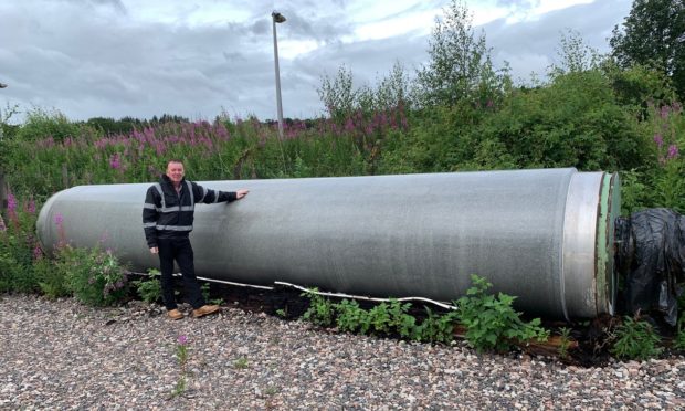 Former mill worker Graeme Sutherland, beside the granite roll.