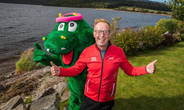 Bryan Burnett with Loch Ness Marathon Nessie ahead of the launch of the virtual Runners cafe this weekend.