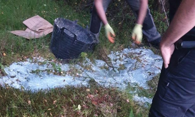 Officers on patrol came across the man disposing of waste at Burgie Wood.