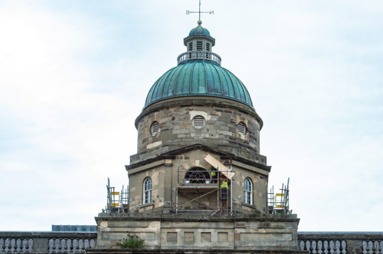 Contractors work to restore the clocks at Dr Gray's Hospital. Photo by Jason Hedges.