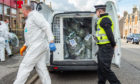 Evidence bags being removed by police at the Highlander Hotel in Buckie, Moray. Picture: Jason Hedges