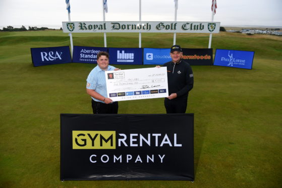 Picture by SANDY McCOOK    
Royal Dornoch Masters competition as part of the Tartan Pro Tour winner Chris MacLean receives his winners trophy and cheque from Paul Lawrie afer a playoff in Dornoch last night.