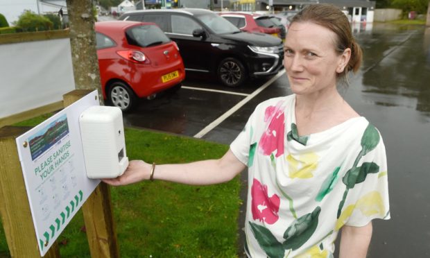 Caroline Gregory of Fort Augustus with the village car park hand sanitiser.
Picture by Sandy McCook.