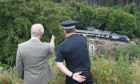The Prince of Wales is shown the scene of the ScotRail train derailment near Stonehaven
