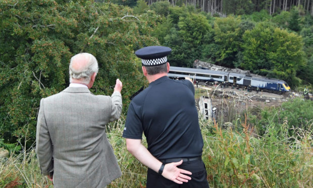 The Prince of Wales is shown the scene of the ScotRail train derailment near Stonehaven