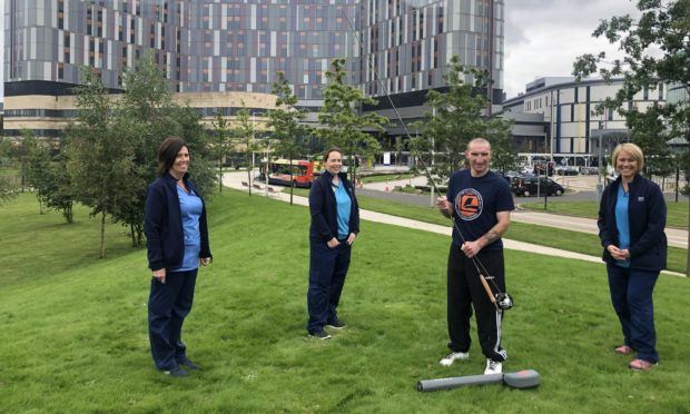 Robbie Bell with nurse Tracey McKissack; physiotherapist Susan Gilhespie and occupational Therapist Amanda Howat outside Glasgow's Queen Elizabeth University Hospital.